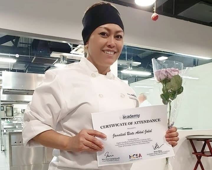 Jamaliah holding HCSA Academy Certificate